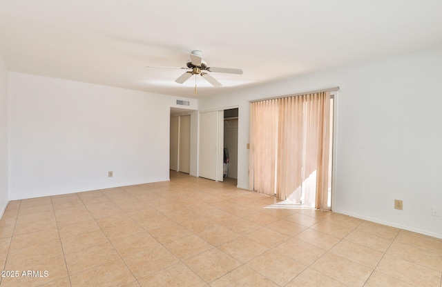 unfurnished bedroom with baseboards, a closet, visible vents, and a ceiling fan