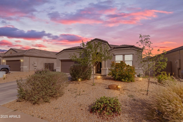 10421 E Cliffrose Ln, Florence, AZ 85132 - view of front facade with an attached garage, stucco siding, and a tile roof
