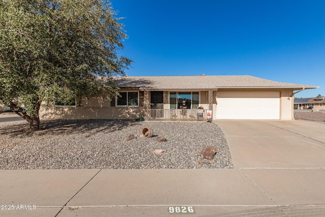 ranch-style house with a garage and covered porch