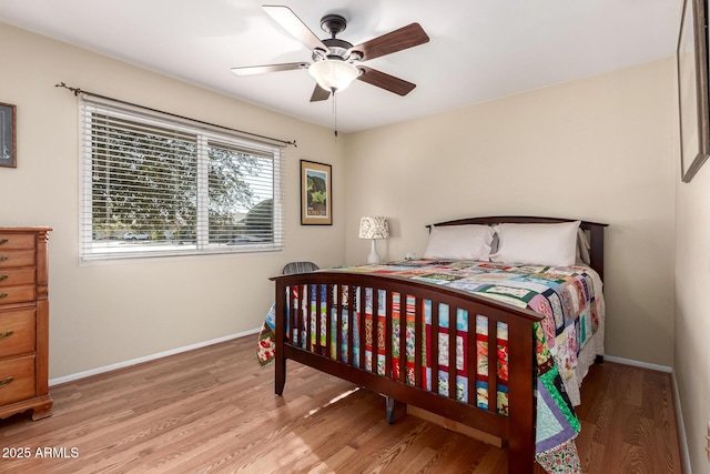 bedroom with ceiling fan and light hardwood / wood-style flooring