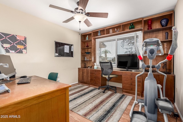 office space with ceiling fan and light hardwood / wood-style flooring