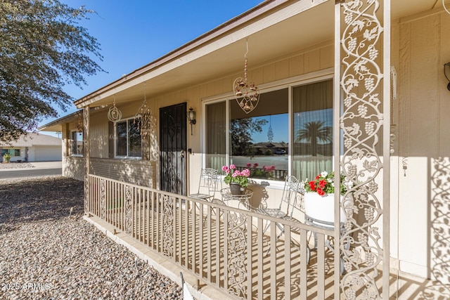 view of exterior entry featuring a porch