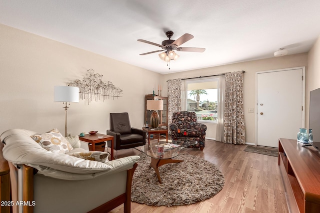 living room featuring hardwood / wood-style flooring and ceiling fan