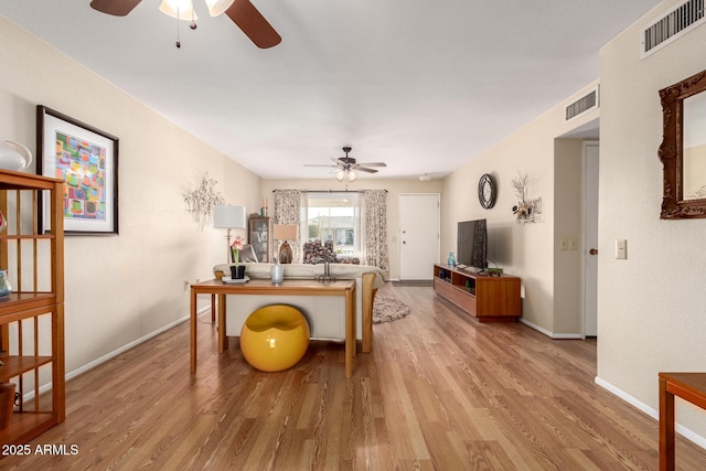 office space with light hardwood / wood-style floors and ceiling fan