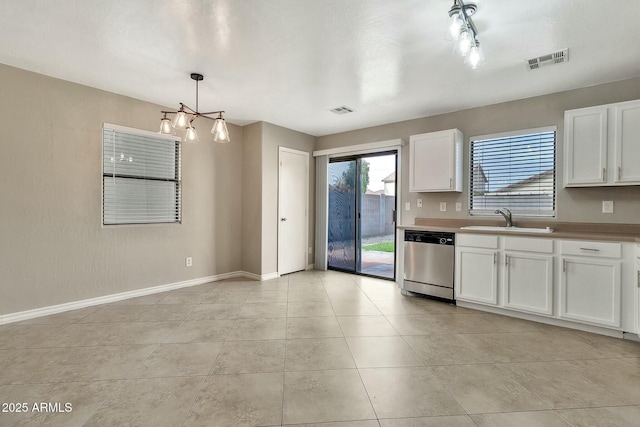 kitchen with stainless steel dishwasher, sink, hanging light fixtures, and white cabinets