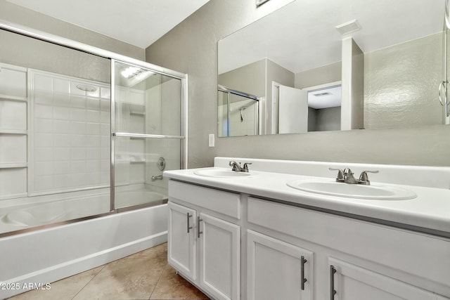 bathroom featuring tile patterned floors, shower / bath combination with glass door, and vanity