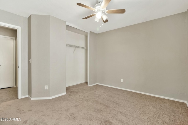 unfurnished bedroom featuring light carpet, a closet, and ceiling fan