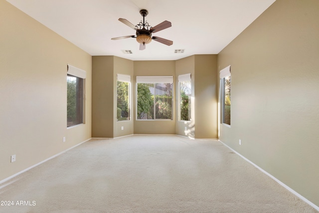 unfurnished room with visible vents, ceiling fan, and baseboards