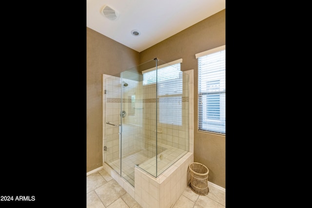 bathroom with a shower stall, baseboards, visible vents, and tile patterned floors