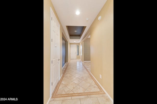 hallway featuring light tile patterned floors, baseboards, and recessed lighting