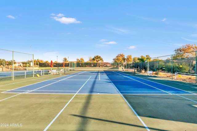 view of sport court featuring fence