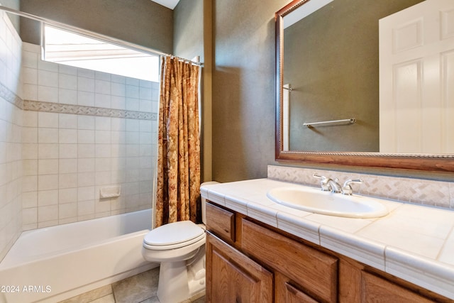 bathroom with tile patterned floors, toilet, vanity, and shower / bath combo