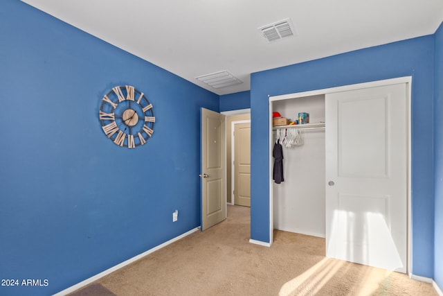 unfurnished bedroom with a closet and light colored carpet