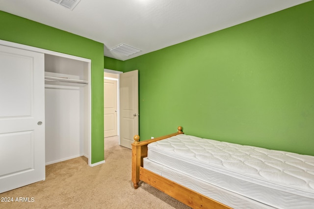 carpeted bedroom featuring a closet