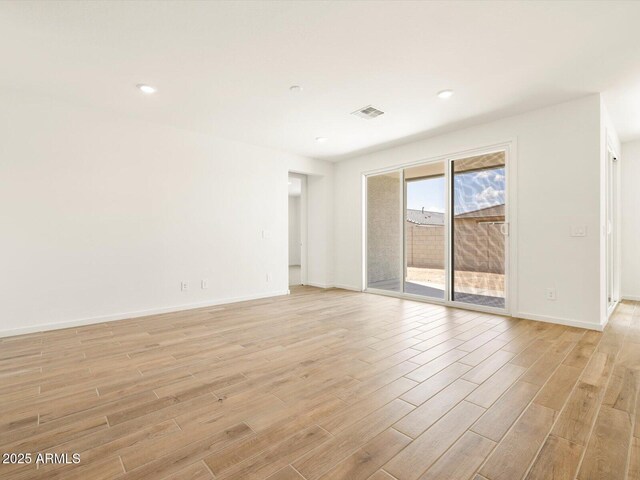 unfurnished room with visible vents, light wood-style flooring, recessed lighting, and baseboards