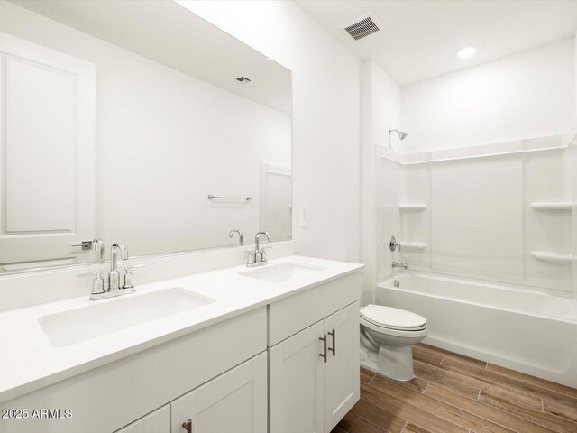 full bath featuring a sink, visible vents, toilet, and wood tiled floor