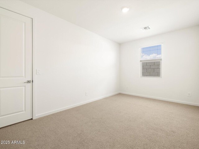 unfurnished room featuring light colored carpet, baseboards, and visible vents