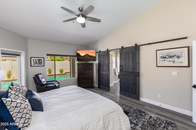 bedroom featuring a ceiling fan, wood finished floors, a barn door, baseboards, and lofted ceiling