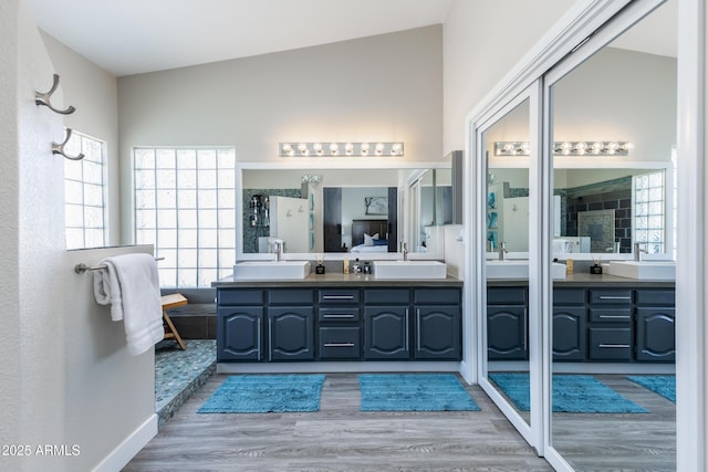 full bathroom with vanity and wood finished floors