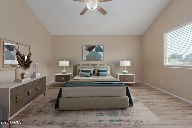 bedroom with a ceiling fan, lofted ceiling, baseboards, and light wood-type flooring