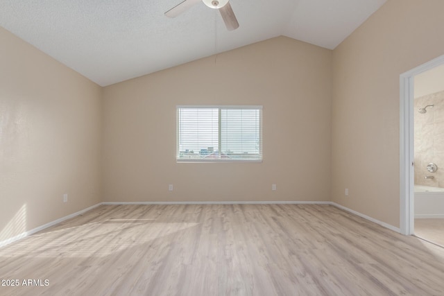 empty room with light wood-style flooring, baseboards, lofted ceiling, and ceiling fan