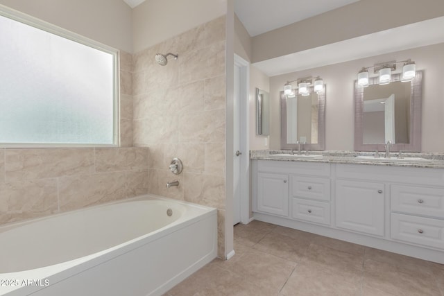 full bath featuring a sink, double vanity, and tile patterned floors