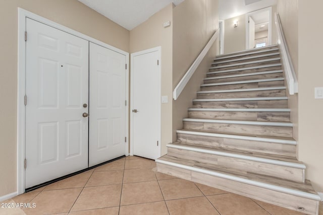 tiled foyer with stairway