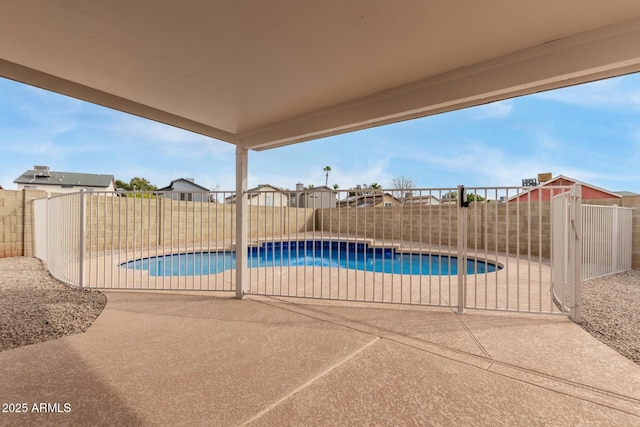 view of swimming pool with a patio, a fenced in pool, and a fenced backyard