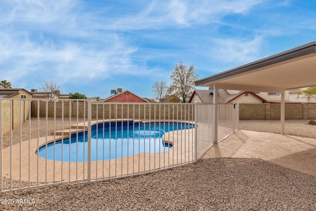 view of swimming pool featuring a patio, a fenced backyard, and a fenced in pool