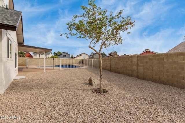 view of yard with a fenced backyard, a fenced in pool, and a patio