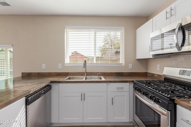 kitchen featuring plenty of natural light, visible vents, appliances with stainless steel finishes, and a sink