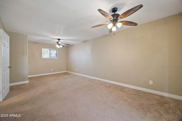 carpeted spare room featuring ceiling fan