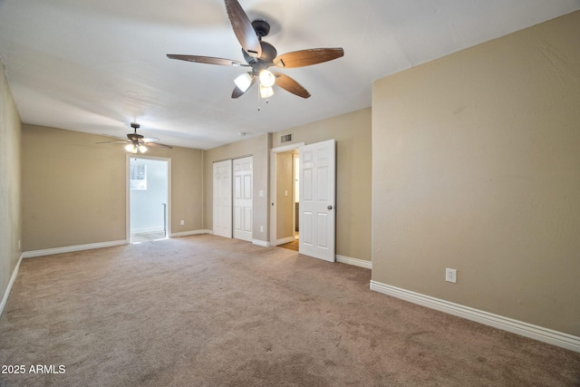 empty room featuring light carpet and ceiling fan