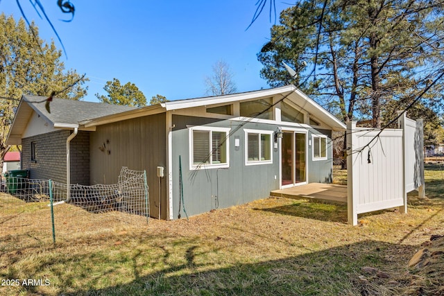 view of side of property with a yard