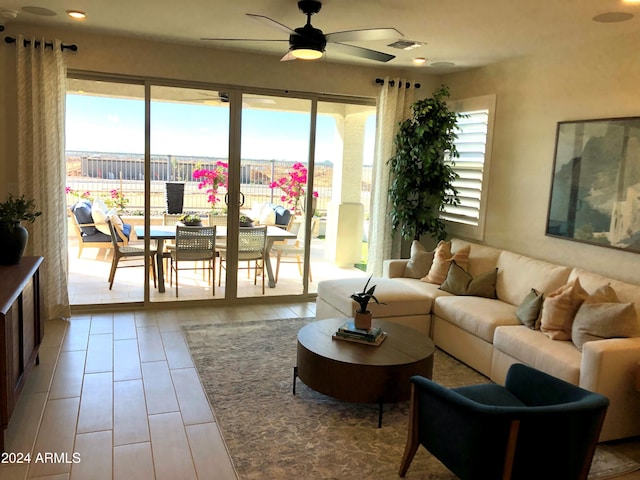 living room featuring ceiling fan and plenty of natural light