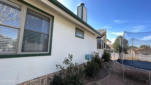 view of side of home featuring a trampoline