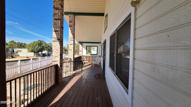 wooden terrace featuring covered porch