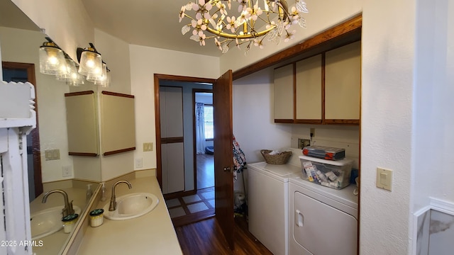 washroom featuring washing machine and dryer and sink