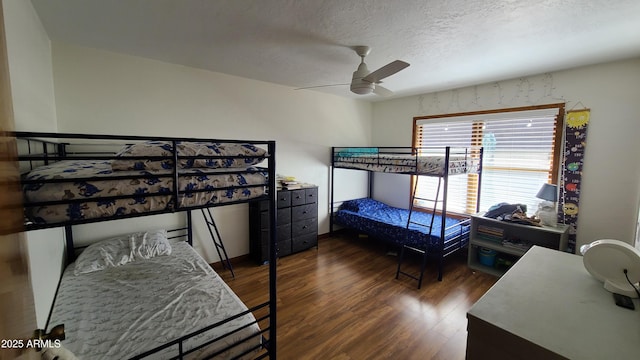 bedroom featuring dark hardwood / wood-style flooring, ceiling fan, and a textured ceiling