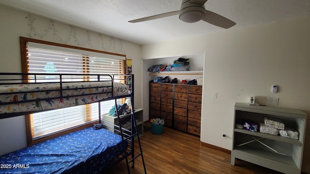 bedroom with wood-type flooring and ceiling fan