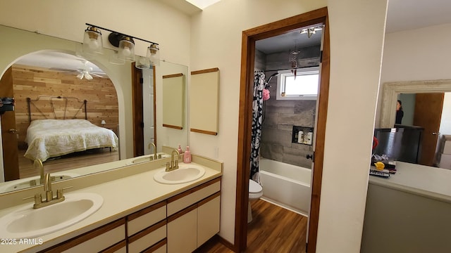 full bathroom featuring shower / tub combo with curtain, vanity, hardwood / wood-style flooring, and toilet