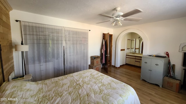 bedroom featuring ceiling fan, sink, and dark hardwood / wood-style flooring