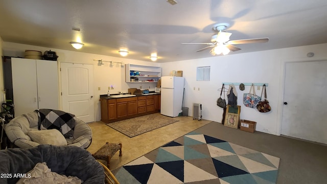 kitchen featuring sink, ceiling fan, and white fridge