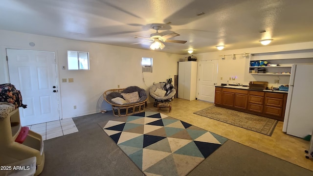 interior space with ceiling fan and sink