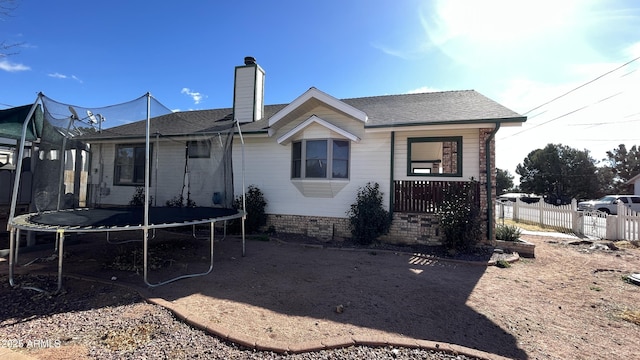 rear view of house with a trampoline