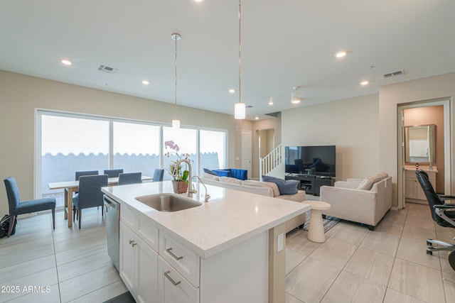 281 E Shamrock Dr, Chandler, AZ 85286 - kitchen featuring stainless steel dishwasher, white cabinetry, open floor plan, a center island with sink, and pendant lighting
