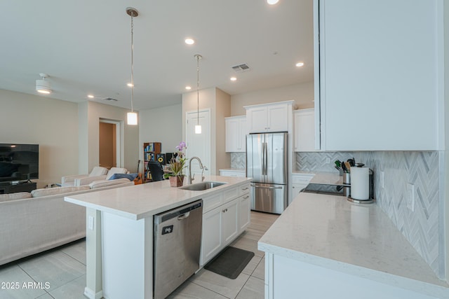 281 E Shamrock Dr, Chandler, AZ 85286 - kitchen featuring stainless steel appliances, backsplash, open floor plan, white cabinetry, and recessed lighting