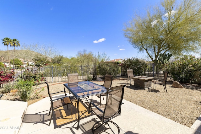 view of patio / terrace with a mountain view and an outdoor fire pit