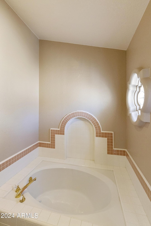 bathroom with tiled bath