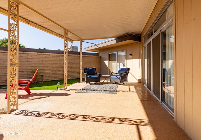 view of patio featuring fence